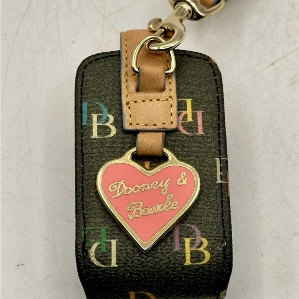 Dooney & Bourke tech/earbud case with Pink Heart Charm. Approx 4” x 3.25”.